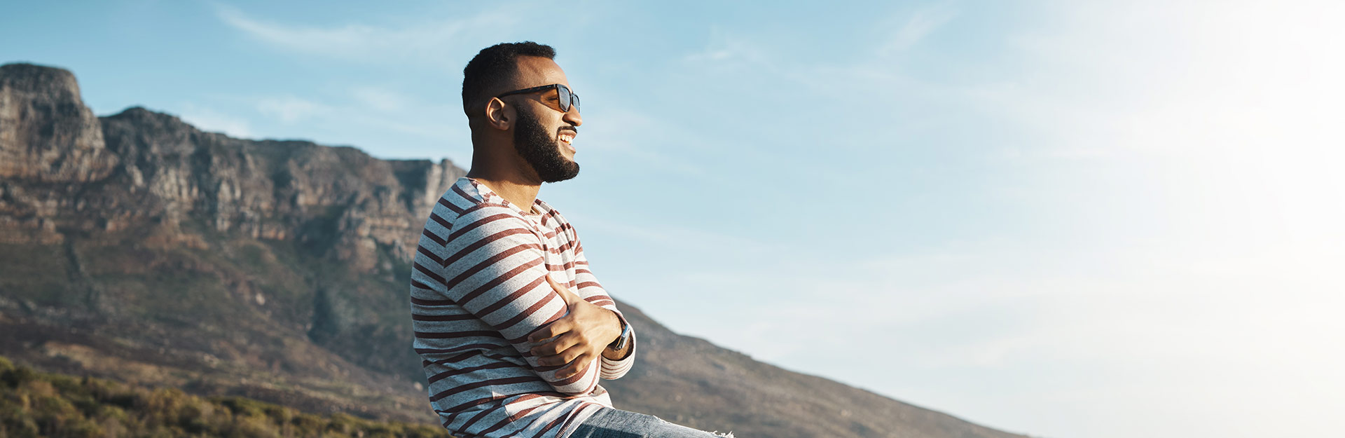 Smiling man in mountain setting looking into the distance