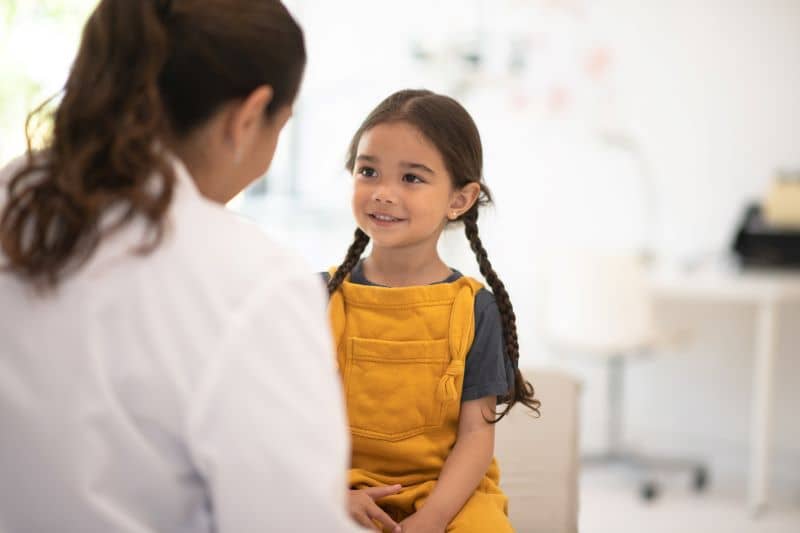 A female child visits with pediatrician. A female child visits with pediatrician.