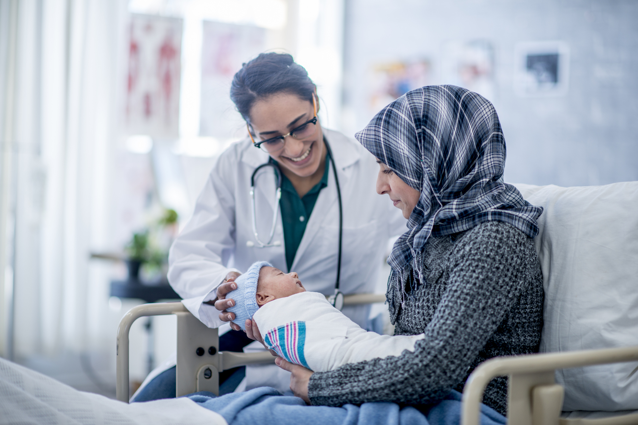 A mother and her newborn accompanied by a female doctor. A mother and her newborn accompanied by a female doctor.