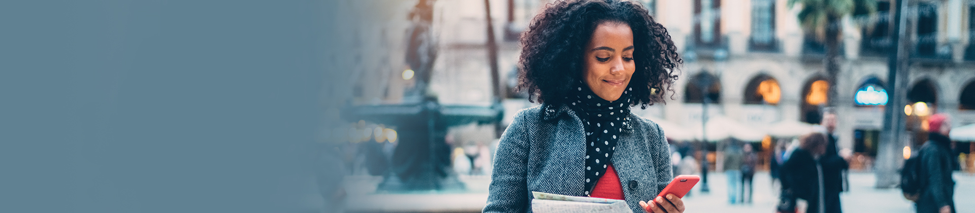 Woman in coat looking at cellphone