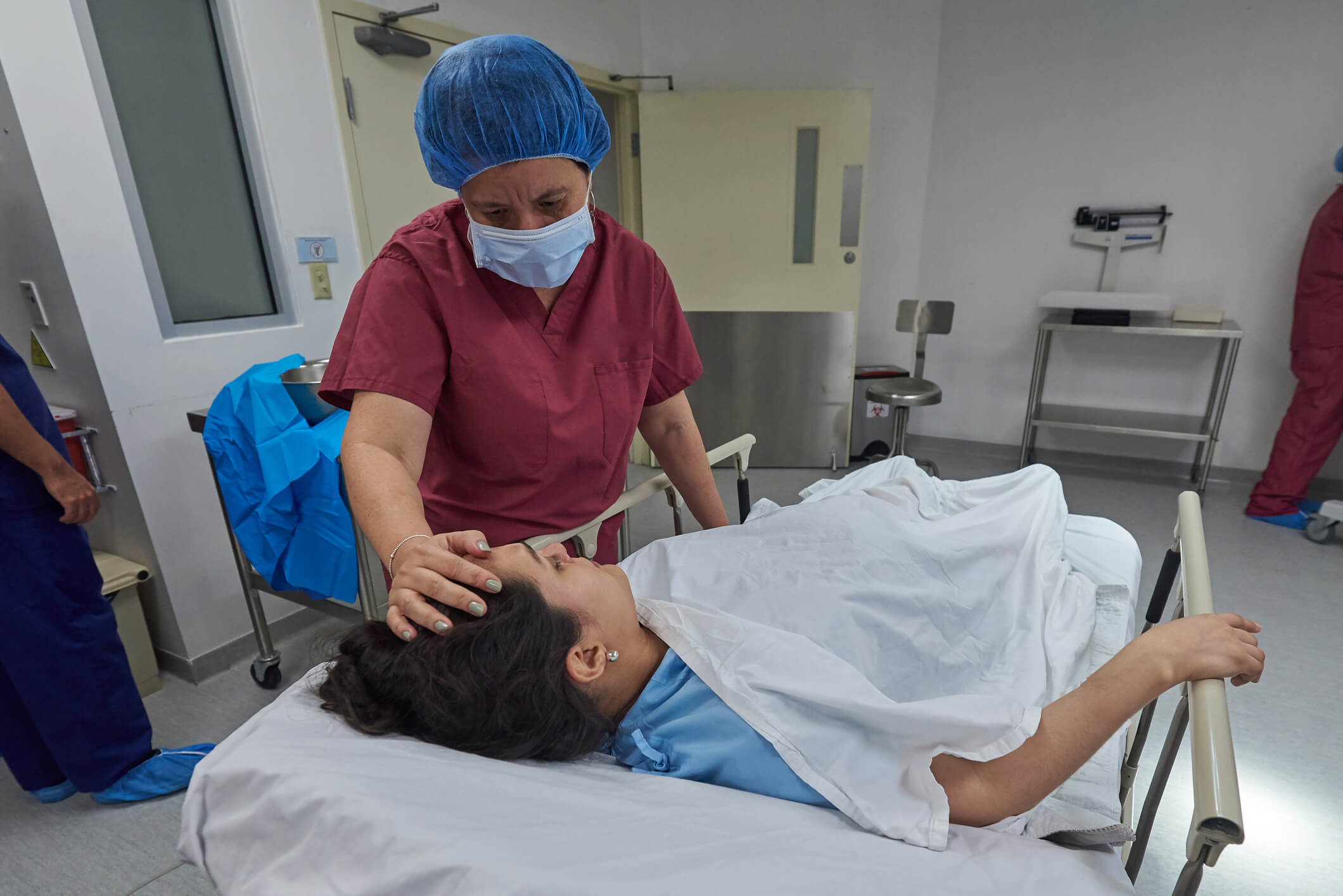 nurse comforting patient post surgery